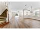 Spacious living area with modern floors and an open floor plan. Features include staircase and natural light at 20146 Heritage Point Dr, Tampa, FL 33647