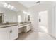 Bright primary bathroom featuring double sink vanity, granite countertop and ceramic tile floor at 20146 Heritage Point Dr, Tampa, FL 33647
