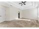 Spacious main bedroom with tray ceiling, neutral carpet, and ensuite bathroom entrance at 20146 Heritage Point Dr, Tampa, FL 33647