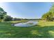 This property includes a well-manicured lawn that gently slopes down to a tranquil pond at 20146 Heritage Point Dr, Tampa, FL 33647