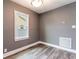 Bedroom featuring gray walls, white trim, wood floor and ample natural light at 2017 Oceanview Pl, Tampa, FL 33605