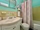 Cozy bathroom features decorative shower curtain, tilework, and a vanity at 2469 Franciscan Dr # 53, Clearwater, FL 33763