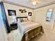 Comfortable bedroom features large bed, bedside tables, and framed decor at 2469 Franciscan Dr # 53, Clearwater, FL 33763