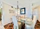 Elegant dining area featuring a glass table, upholstered chairs, and modern lighting at 2469 Franciscan Dr # 53, Clearwater, FL 33763
