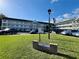 Exterior view of American Gothic, a multi-story condo complex with manicured lawn at 2469 Franciscan Dr # 53, Clearwater, FL 33763