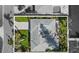 Aerial view of the house showcasing the roof shape, backyard, and driveway access at 2540 S Shore Se Dr, St Petersburg, FL 33705
