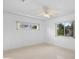 Bedroom view highlighting natural light with two windows and ceiling fan at 2540 S Shore Se Dr, St Petersburg, FL 33705