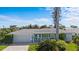 Charming home featuring brick driveway, manicured lawn and lush tropical landscaping at 2540 S Shore Se Dr, St Petersburg, FL 33705