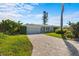 Inviting single-story home featuring a brick driveway and lush green lawn at 2540 S Shore Se Dr, St Petersburg, FL 33705
