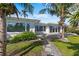 Single-story home with a backyard featuring a paver patio, and lush lawn on a canal at 2540 S Shore Se Dr, St Petersburg, FL 33705