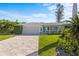 Well-maintained single-story home with a brick driveway and manicured lawn at 2540 S Shore Se Dr, St Petersburg, FL 33705