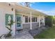 Welcoming front porch with decorative mermaid decor and colorful stained glass door at 2540 S Shore Se Dr, St Petersburg, FL 33705