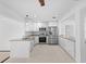 Updated kitchen with stainless steel appliances, granite counters, and white cabinetry at 2540 S Shore Se Dr, St Petersburg, FL 33705