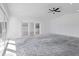 A bright and open living room with concrete flooring and sliding glass doors at 2540 S Shore Se Dr, St Petersburg, FL 33705