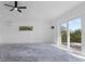 Bright, open living room boasts a sleek ceiling fan and patio doors, modern design at 2540 S Shore Se Dr, St Petersburg, FL 33705