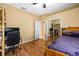 Bedroom with wood floor, ceiling fan, closet, and sliding glass closet doors at 2613 Bonterra Blvd, Valrico, FL 33594