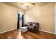 Bedroom with wood floor, ceiling fan, window and loveseat at 2613 Bonterra Blvd, Valrico, FL 33594