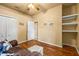 Bedroom with wood floor, ceiling fan, double closet and comfortable seating at 2613 Bonterra Blvd, Valrico, FL 33594