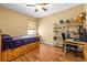 Bedroom with wood floor, ceiling fan, shelving unit and platform bed at 2613 Bonterra Blvd, Valrico, FL 33594