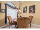 A bright breakfast nook features a round table, decorative chairs, and large window with views of the landscaping at 2613 Bonterra Blvd, Valrico, FL 33594