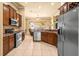 Well-equipped kitchen with granite counters, stainless steel appliances, and tile floors at 2613 Bonterra Blvd, Valrico, FL 33594