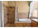 A luxurious main bathroom features a walk-in shower and soaking tub with tile surround at 2613 Bonterra Blvd, Valrico, FL 33594