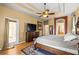 A spacious main bedroom features a tray ceiling, dresser, and adjacent bathroom at 2613 Bonterra Blvd, Valrico, FL 33594