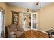 Inviting home office with wood floors, ceiling fan, comfortable chair and view to hall at 2613 Bonterra Blvd, Valrico, FL 33594