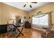 Home office with a vaulted ceiling, wood floors, decorative window, and comfortable seating at 2613 Bonterra Blvd, Valrico, FL 33594