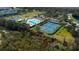 Aerial view of the community amenities including a pool, tennis courts, and recreational areas at 3009 Sheehan Dr, Land O Lakes, FL 34638