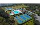 Aerial view of the community amenities including a pool, tennis courts, and recreational areas at 3009 Sheehan Dr, Land O Lakes, FL 34638