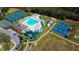 Aerial view of community with pool, playground, basketball courts, tennis courts, and green spaces at 3009 Sheehan Dr, Land O Lakes, FL 34638
