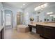 Bright bathroom with a large soaking tub, walk-in shower, and vanity area at 3009 Sheehan Dr, Land O Lakes, FL 34638