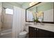 Bathroom featuring a shower-tub combo with white shower curtain and a brown vanity at 3009 Sheehan Dr, Land O Lakes, FL 34638