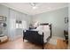 Stylish bedroom featuring a dark wood bed frame, light blue walls, and wood floors at 3009 Sheehan Dr, Land O Lakes, FL 34638