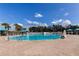 Large community pool with sun loungers and cabanas offering a relaxing oasis for residents under a bright blue sky at 3009 Sheehan Dr, Land O Lakes, FL 34638