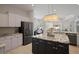 Modern kitchen with stainless steel appliances, granite countertops, and a large island at 3009 Sheehan Dr, Land O Lakes, FL 34638