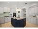 Well-appointed kitchen with a central island, white cabinets, and modern appliances at 3009 Sheehan Dr, Land O Lakes, FL 34638