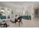 Spacious living room with tiled floors, tray ceiling, and views of the screened-in lanai and backyard at 3009 Sheehan Dr, Land O Lakes, FL 34638