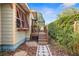 Side yard featuring stepping stones leading to the elevated deck with patio furniture at 3120 8Th N Ave, St Petersburg, FL 33713
