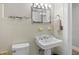This is a well-lit bathroom with tile floors, a classic sink, and a sleek modern toilet at 3120 8Th N Ave, St Petersburg, FL 33713