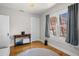 A living space with hardwood floors, a desk, and lots of natural light coming from a large window at 3120 8Th N Ave, St Petersburg, FL 33713