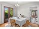 Charming dining room with a white table setting, hardwood floors, and views of the outdoor space at 3120 8Th N Ave, St Petersburg, FL 33713