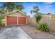 Detached two-car garage with gravel driveway, secured by a wooden fence for added privacy at 3120 8Th N Ave, St Petersburg, FL 33713