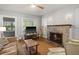 Inviting living room features a brick fireplace, ceiling fan, hardwood floors, and plenty of natural light at 3120 8Th N Ave, St Petersburg, FL 33713