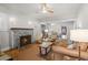 Cozy living room featuring a brick fireplace, hardwood floors, and a ceiling fan at 3120 8Th N Ave, St Petersburg, FL 33713