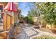 Side yard featuring stepping stones leading to the elevated deck with patio furniture at 3120 8Th N Ave, St Petersburg, FL 33713