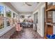 Bright sun room with tile flooring, large windows, and a ceiling fan at 3120 8Th N Ave, St Petersburg, FL 33713