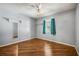 Bright bedroom features hardwood floors, a ceiling fan and window with a view of the outdoors at 34651 Appaloosa Trl, Zephyrhills, FL 33541