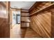 Inviting hallway with warm wood paneling and built-in shelving offering character and functionality at 34651 Appaloosa Trl, Zephyrhills, FL 33541